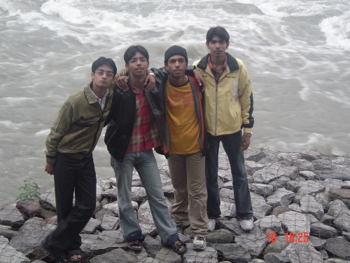Ayush, Rohit, Shubham and Sid standing on a makeshift dam..